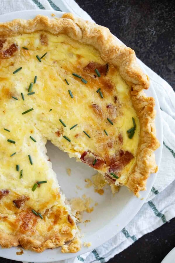 overhead view of quiche lorraine with one slice cut out
