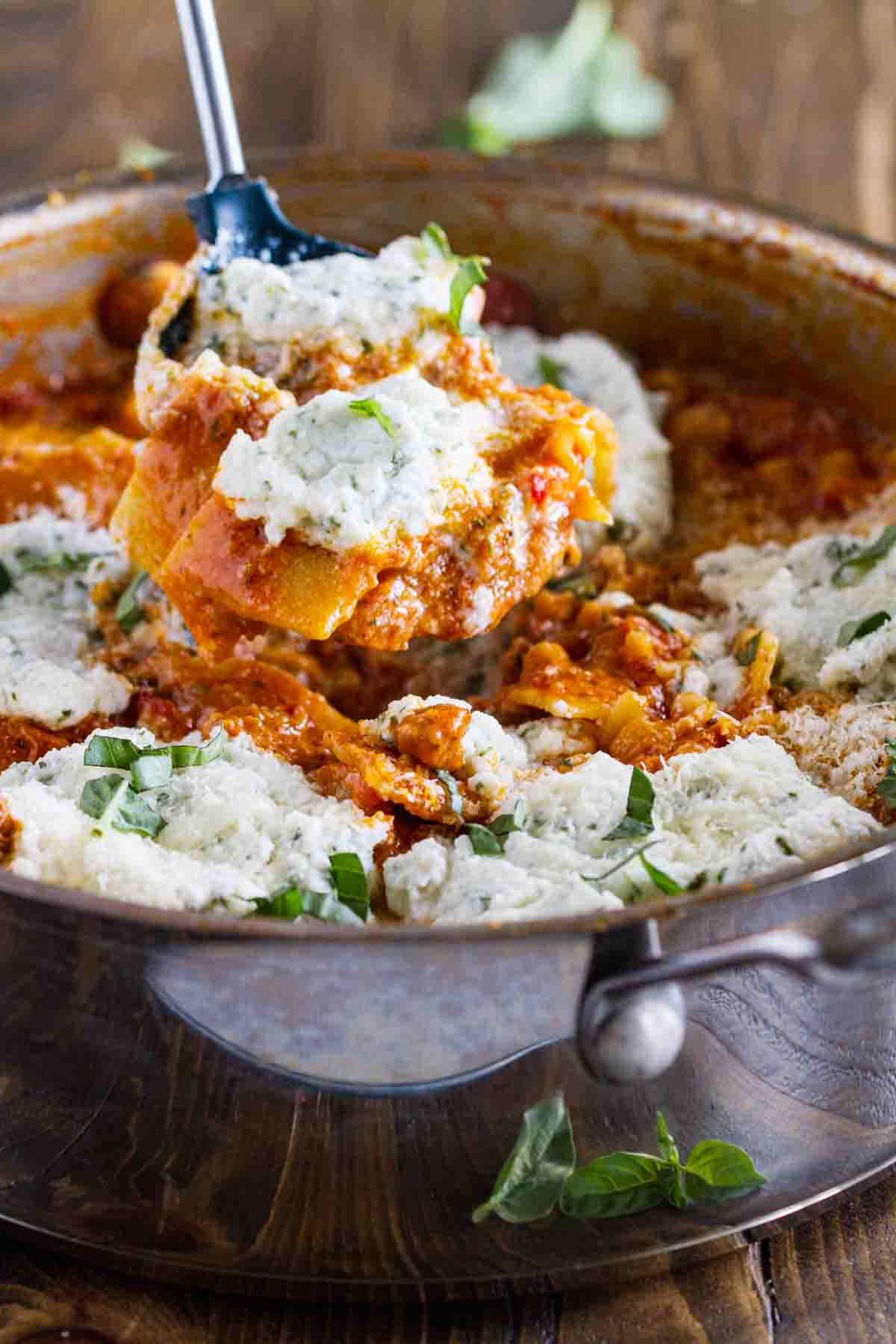 scooping finished skillet lasagna from the pan