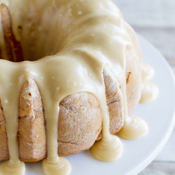 full Apple Bundt Cake with Caramel Frosting dripping down the sides