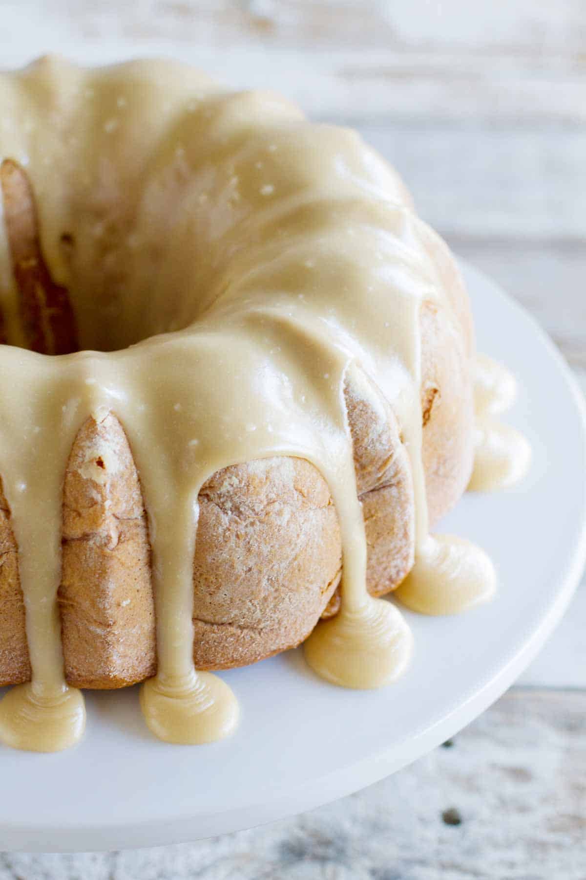 full Apple Bundt Cake with Caramel Frosting dripping down the sides