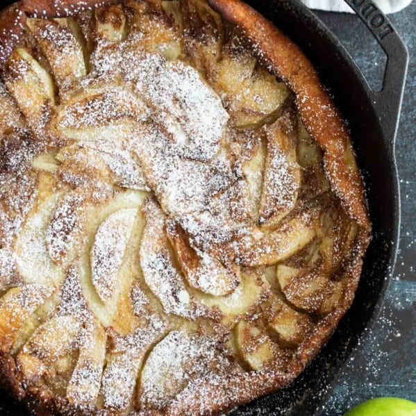 Overhead view of German Apple Pancake with apples on the side