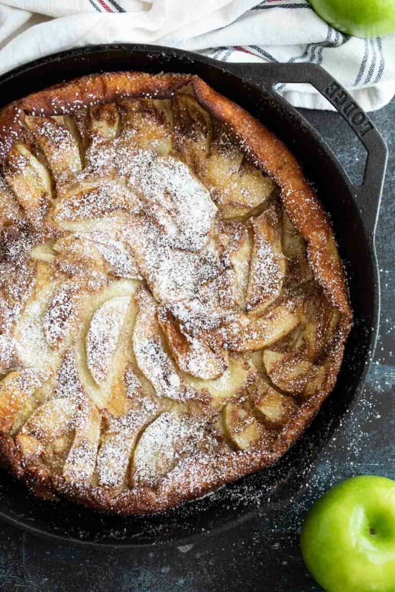 Overhead view of German Apple Pancake with apples on the side