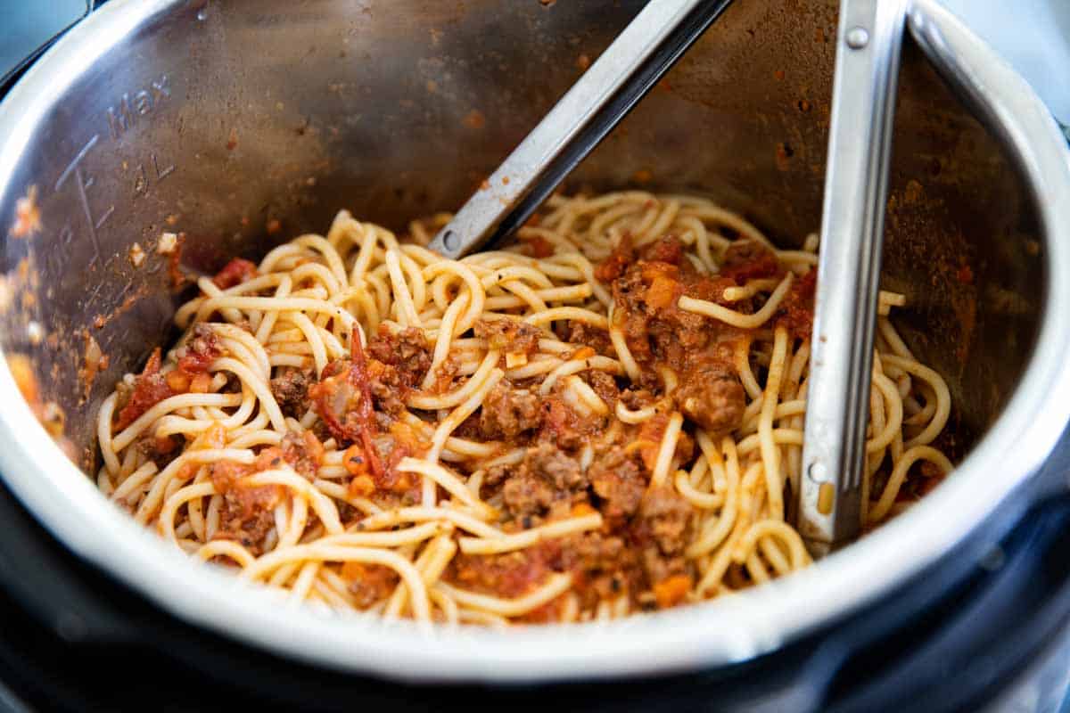 mixing spaghetti into Instant Pot Bolognese