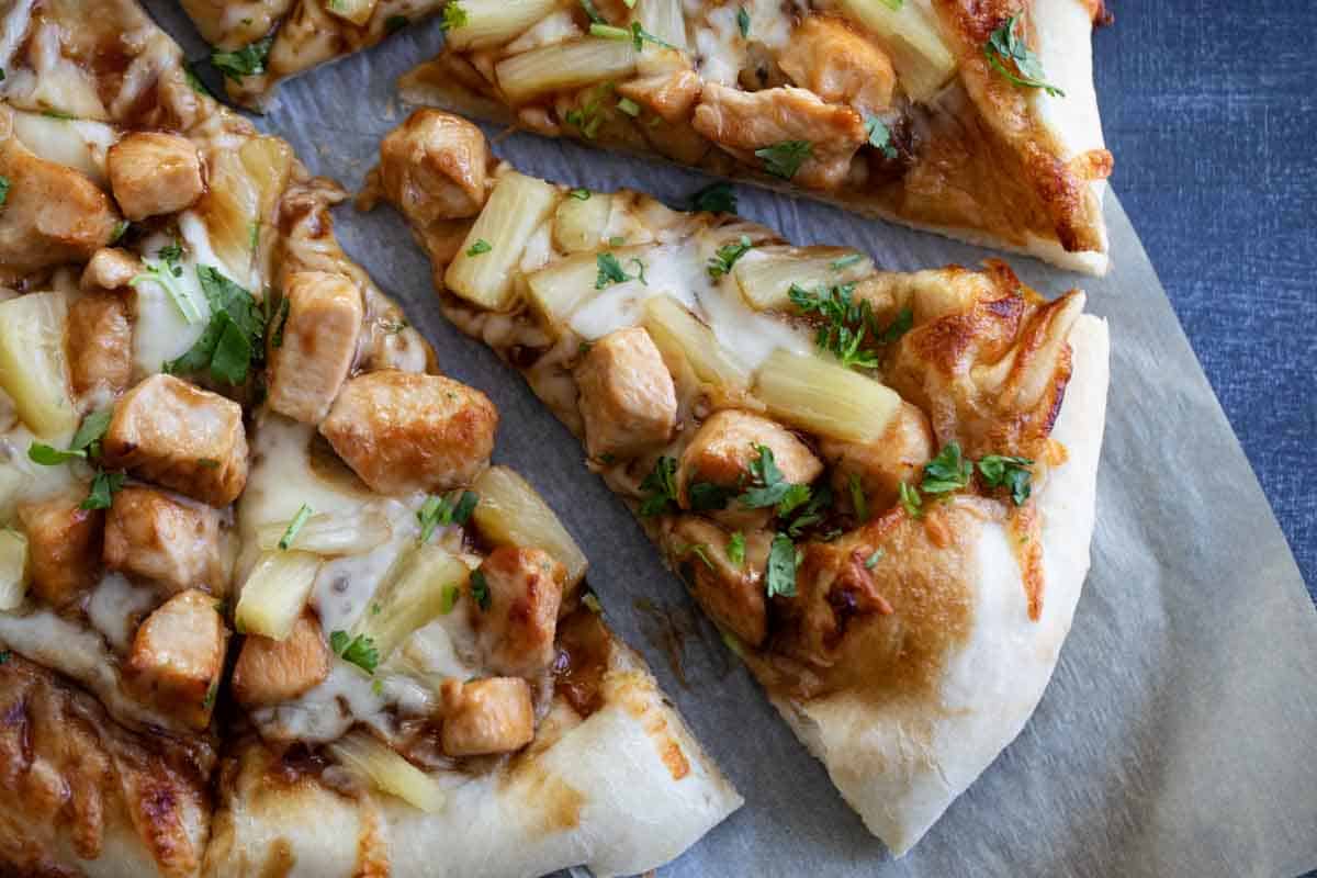 overhead view of pizza with teriyaki, chicken, pineapples and cilantro