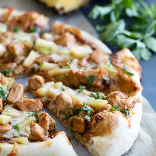 slice of Teriyaki Chicken Pizza beside a whole pizza