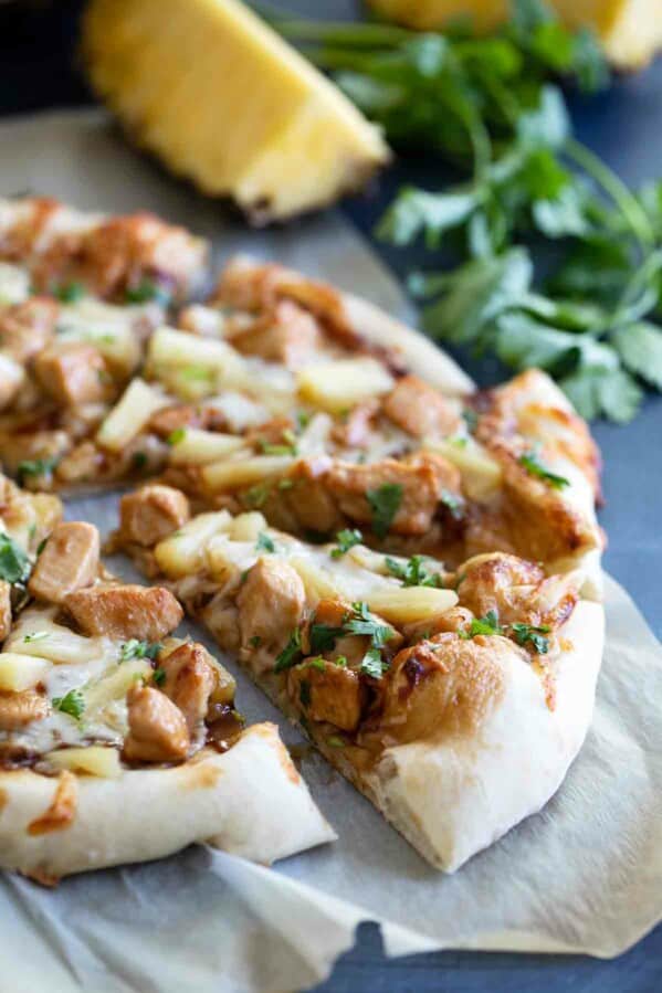 slice of Teriyaki Chicken Pizza beside a whole pizza