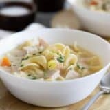 bowl of Creamy Turkey Noodle Soup with a spoon on the side