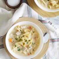 overhead view of Creamy Turkey Noodle Soup in bowls on plates