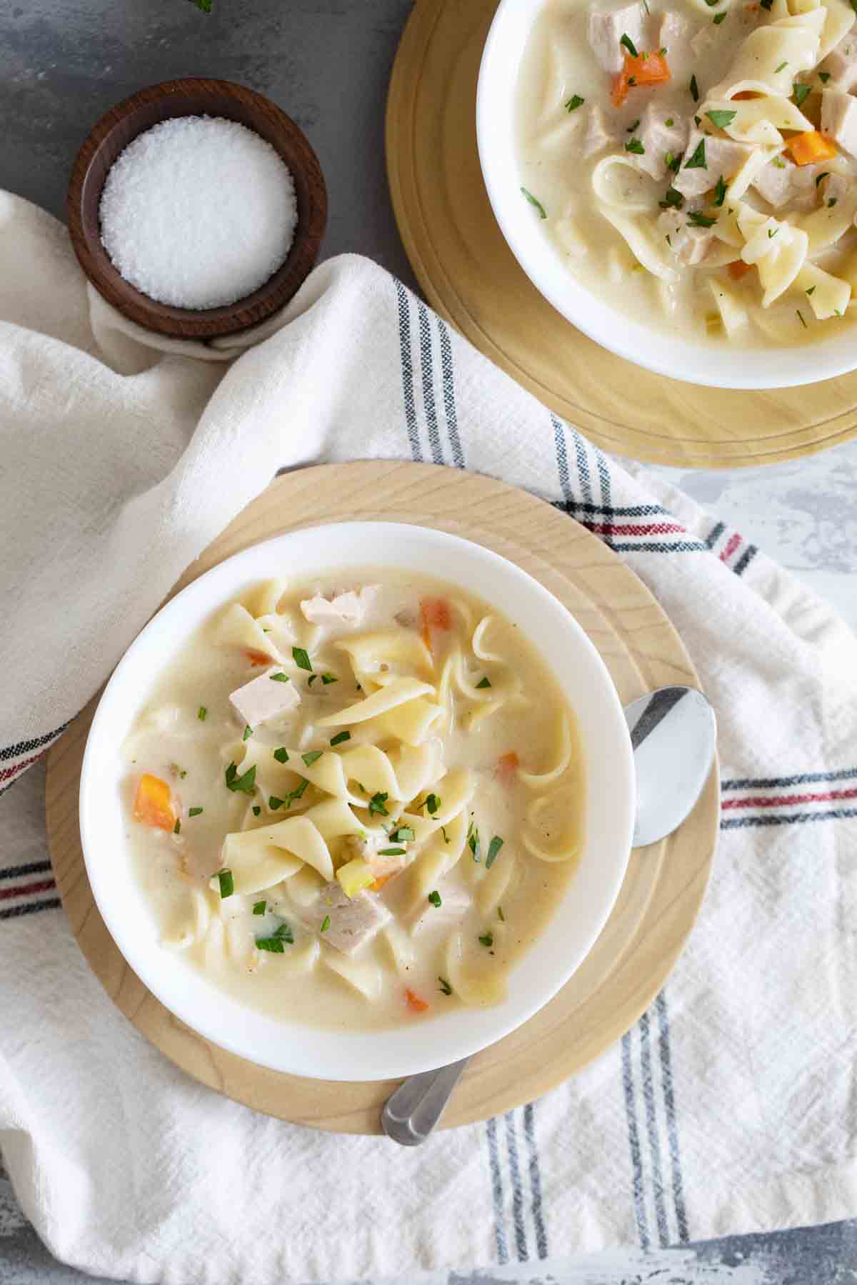 overhead view of Creamy Turkey Noodle Soup in bowls on plates