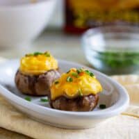 plate with two cheesy mashed potato stuffed mushrooms