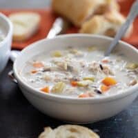 bowl of creamy chicken wild rice soup in a bowl with a spoon