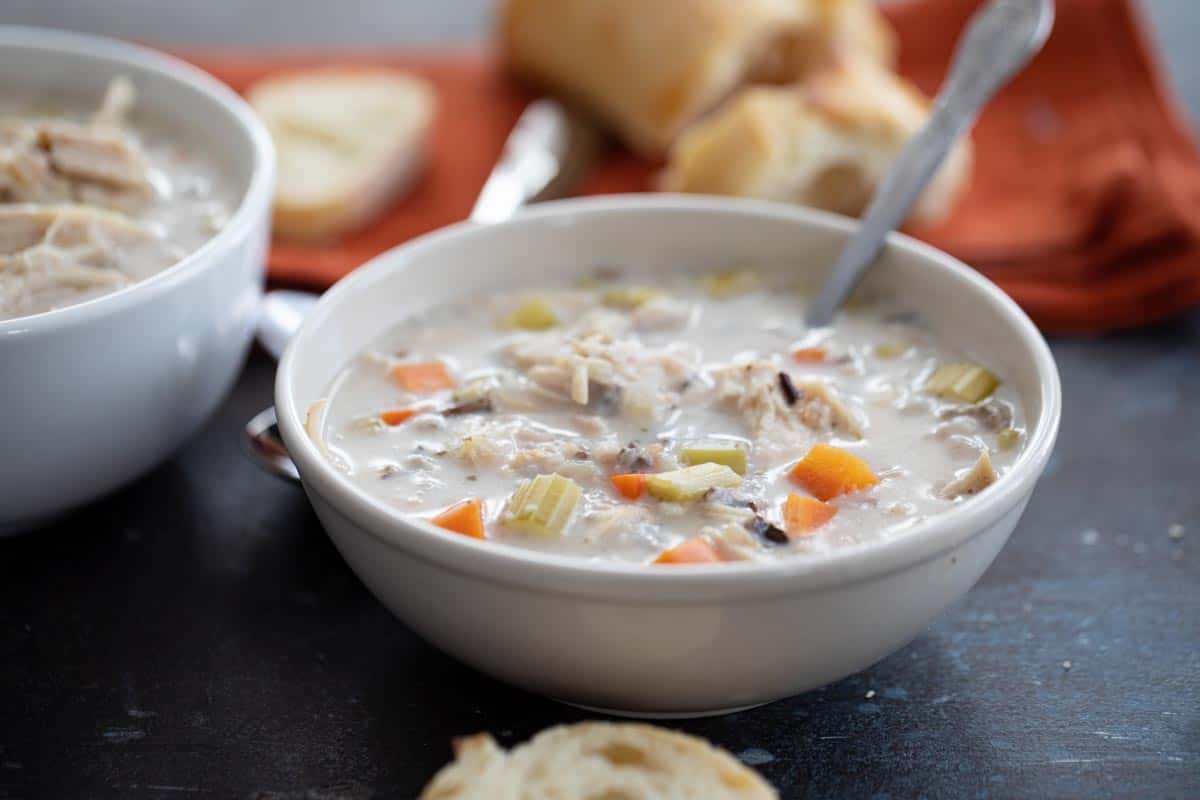 bowl of creamy chicken wild rice soup in a bowl with a spoon