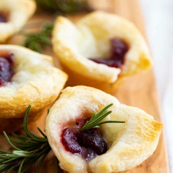 multiple cranberry brie bites on a cutting board