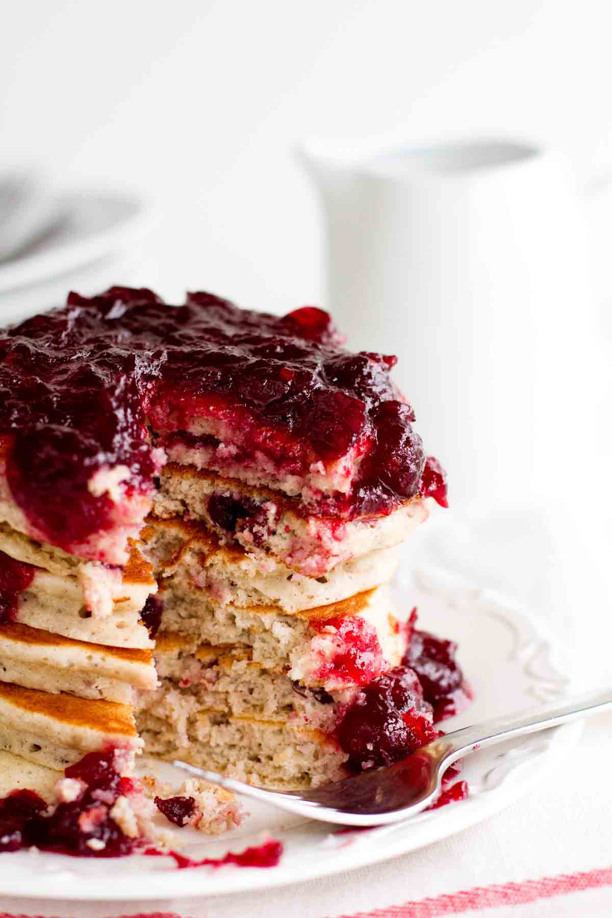 stacked Cranberry Pancakes with a bite taken out