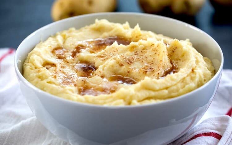 bowl of mashed potatoes topped with brown butter