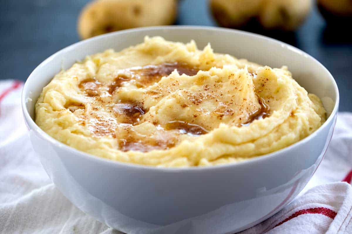 bowl of mashed potatoes topped with brown butter