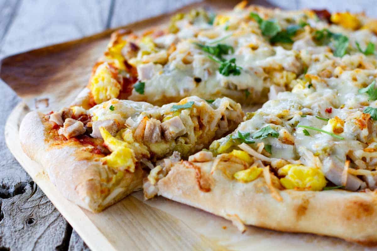 Pizza topped with turkey, eggs and Mexican flavors