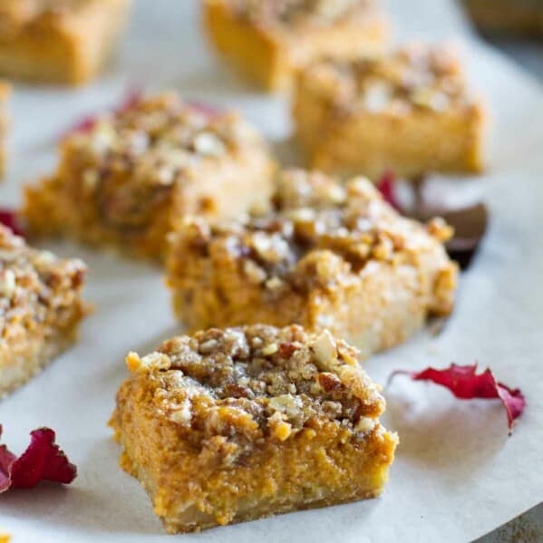 pumpkin pie bars on parchment paper on a tray