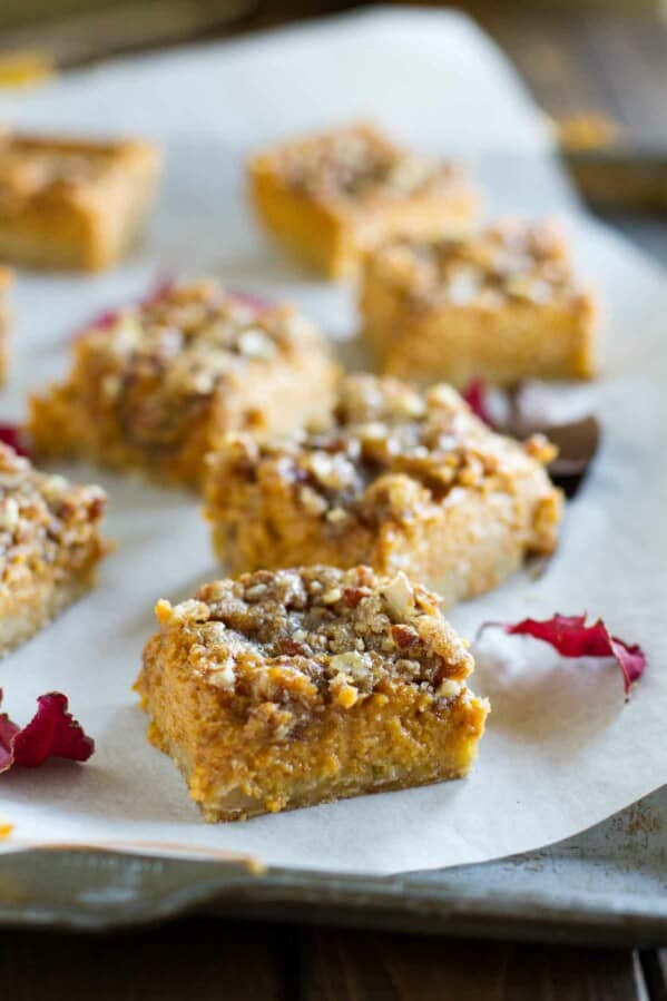 pumpkin pie bars on parchment paper on a tray