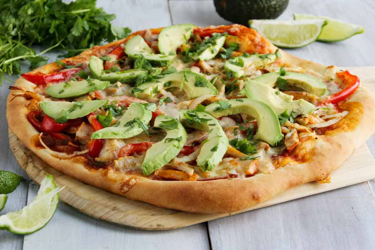 whole turkey fajita pizza topped with avocados