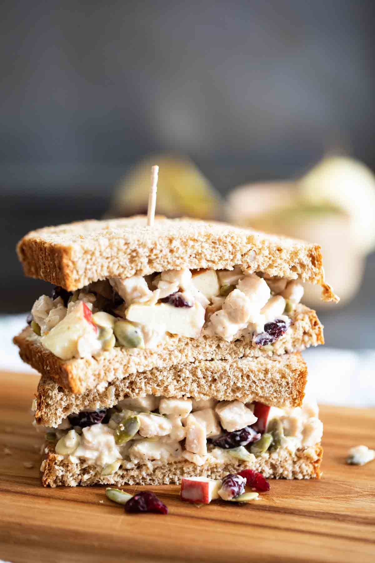 two half turkey salad sandwiches stacked on top of each other