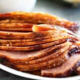 sliced brown sugar glazed ham on a plate