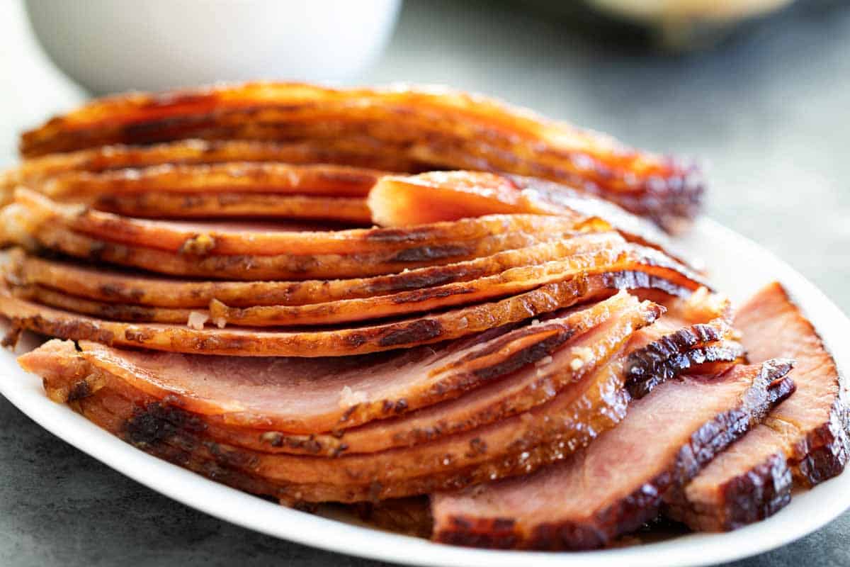 sliced brown sugar glazed ham on a plate