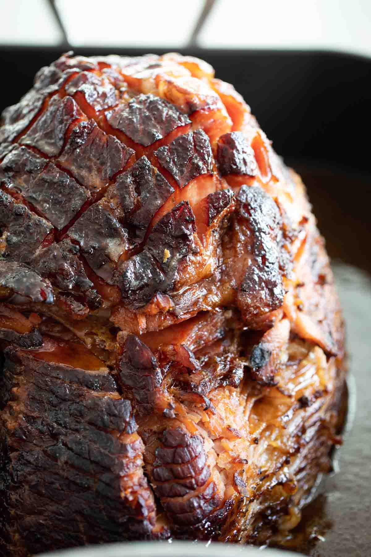 cooked brown sugar glazed ham in a roasting dish