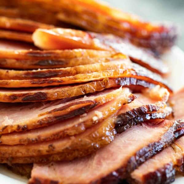 sliced baked ham with ham glaze on a serving dish