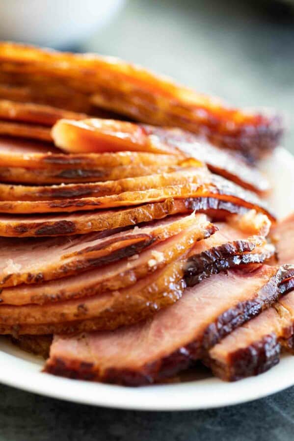 sliced baked ham with ham glaze on a serving dish