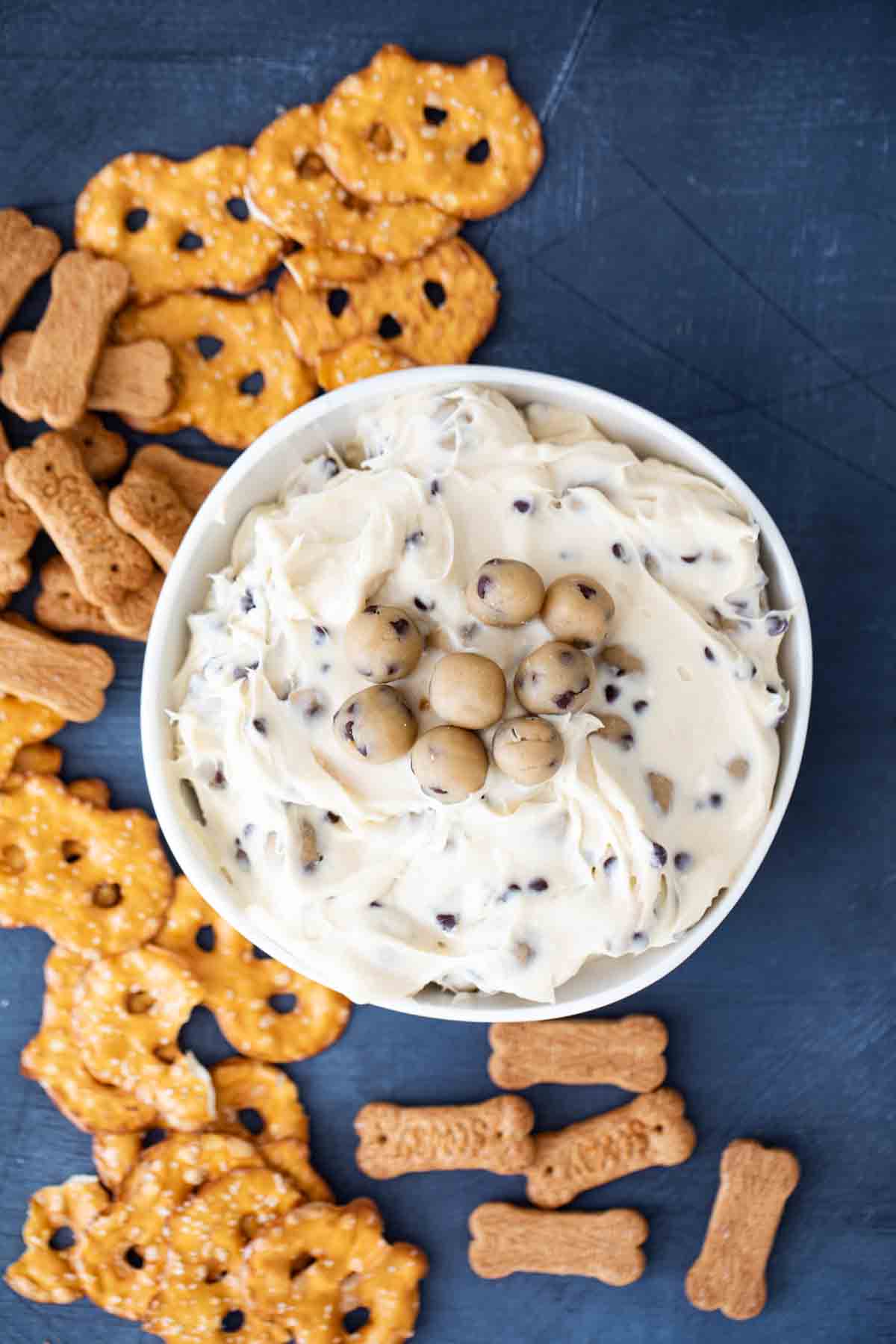 overhead view of chocolate chip cookie dough dip with pretzel crisps and graham crackers