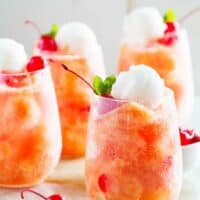 glasses of fruit freeze punch topped with sorbet and cherries