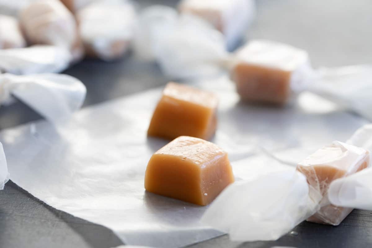 Homemade caramel candies on wax paper