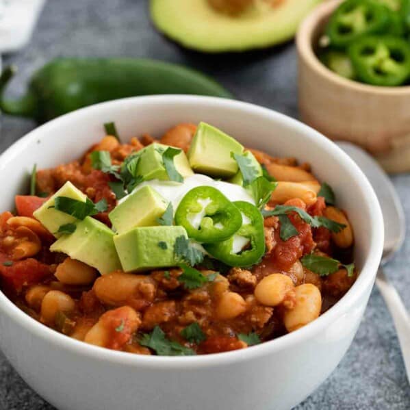 bowl of ground turkey chili with toppings