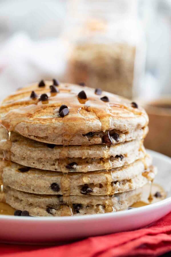 stack of whole wheat oatmeal pancakes drizzled with syrup