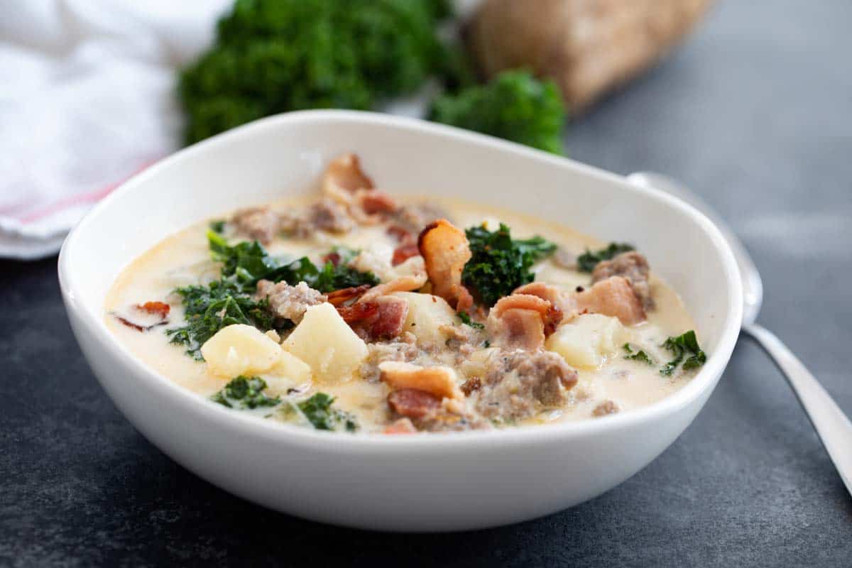 Bowl of Zuppa Toscana topped with bacon