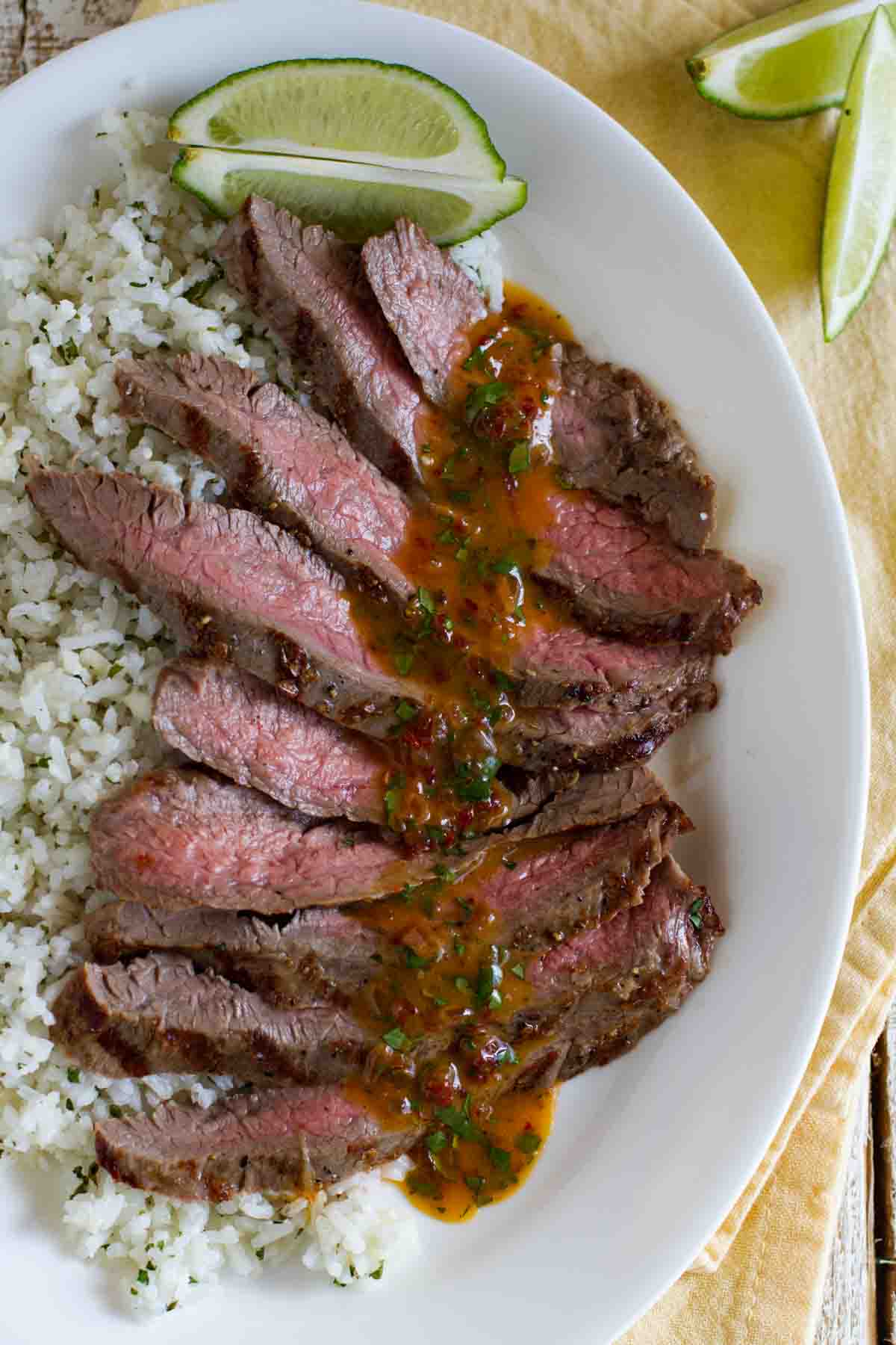 overhead view of sliced flank steak with chipotle butter