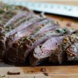 sliced flank steak on a cutting board