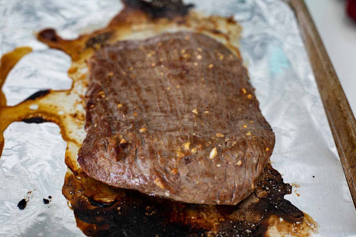 cooked flank steak with flank steak marinade