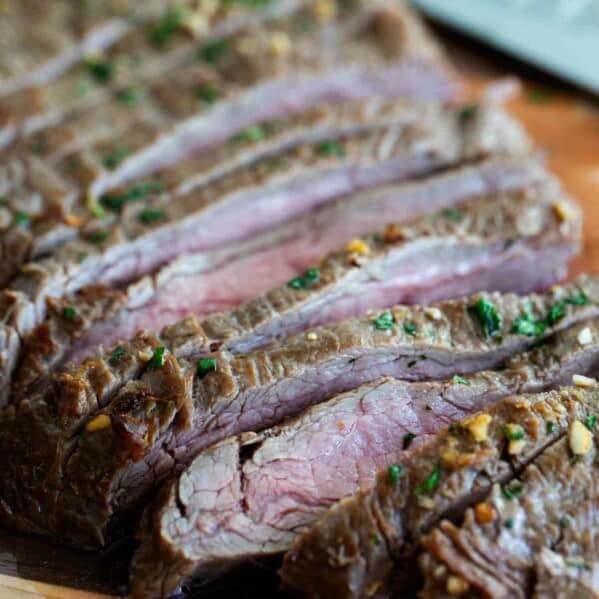 Marinate flank steak on a cutting board cut into slices