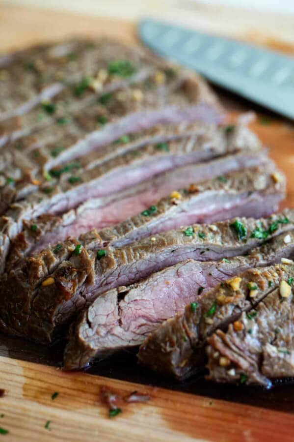 Marinate flank steak on a cutting board cut into slices