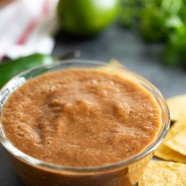 Homemade Salsa in a bowl with ingredients in the background