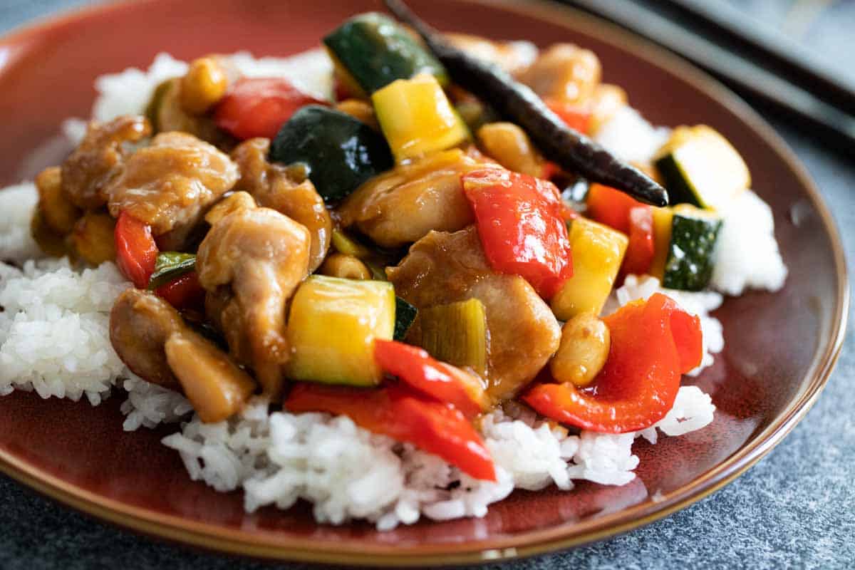 plate of kung pao chicken on rice.