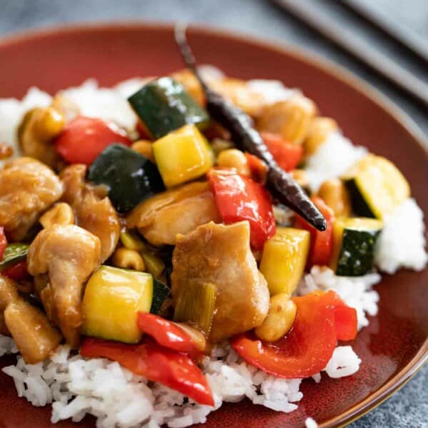 Kung Pao Chicken on a brown plate with rice