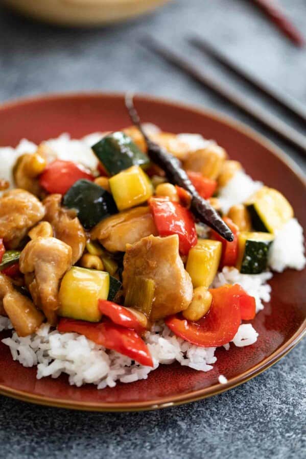 Kung Pao Chicken on a brown plate with rice