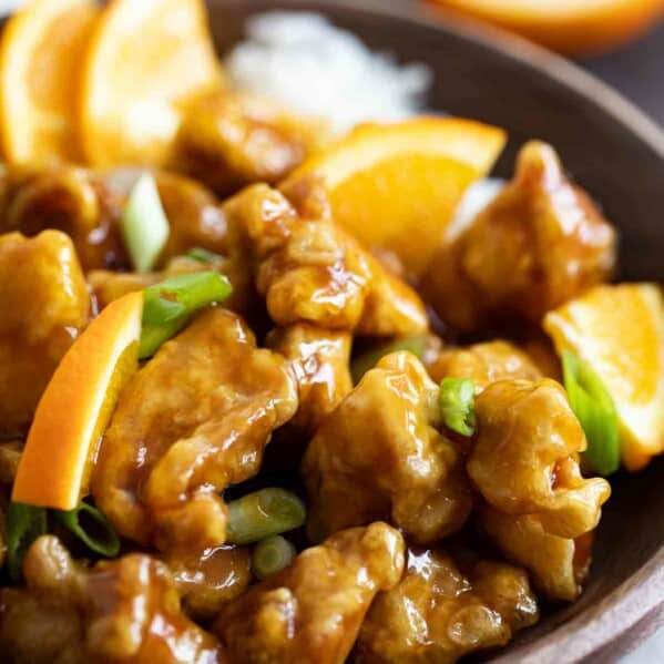 bowl of homemade orange chicken with green onions