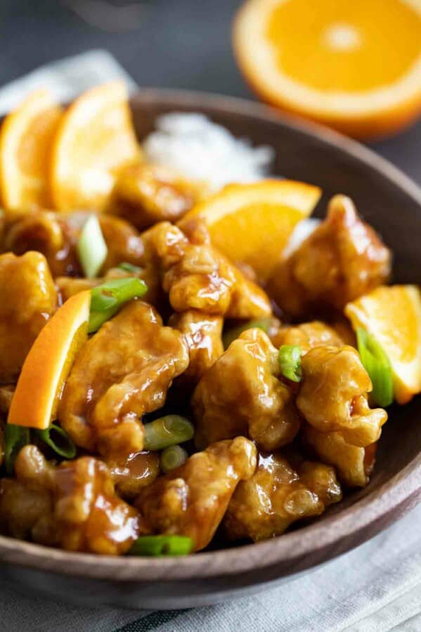 bowl of homemade orange chicken with green onions