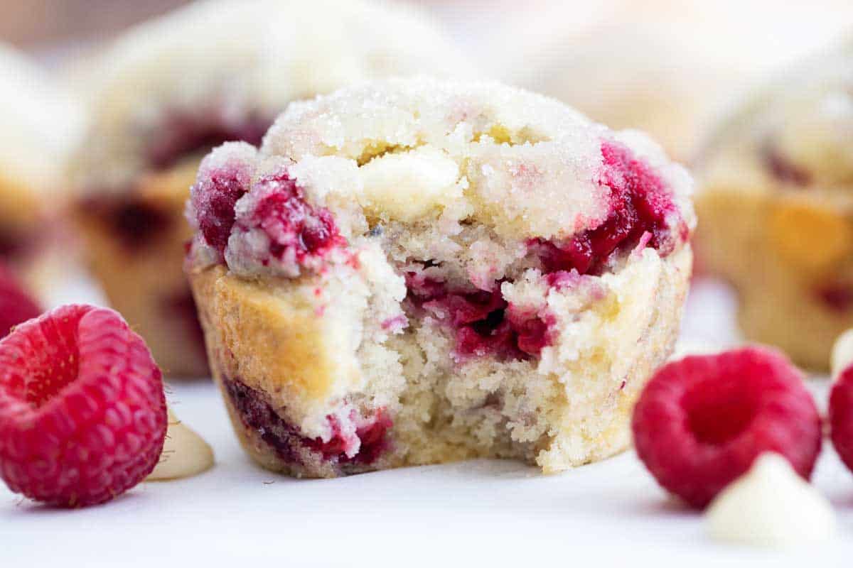 raspberry muffin with a bite taken to show the inside texture