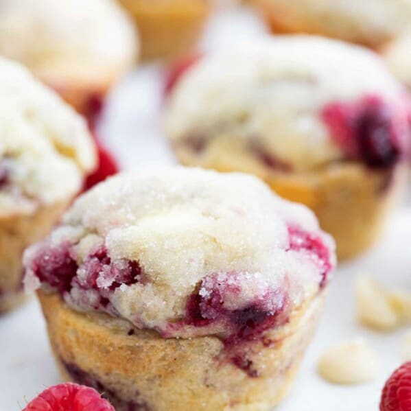 raspberry muffin with white chocolate chips with fresh raspberry on the side