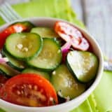 bowl of zucchini salad with tomatoes and red onions